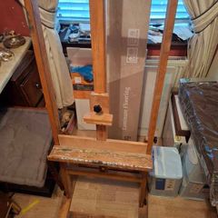 Easel And Selection Of Paints And Book