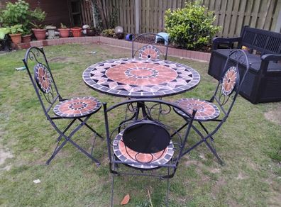 Ceramic table and four chairs.