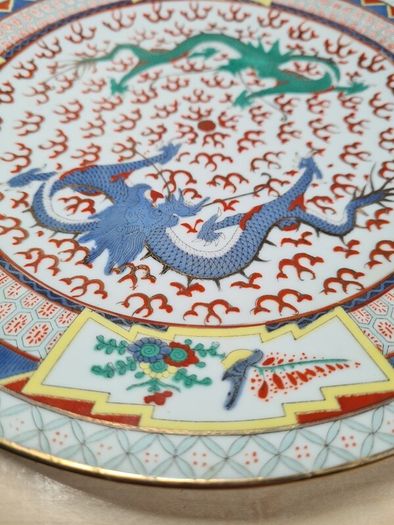 Vintage chinese porcelain plate with dragons decoration hand painted
