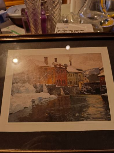 Framed print of  Snow-Covered Buildings by a River by Fritz Thaulow (1847 - 1906).