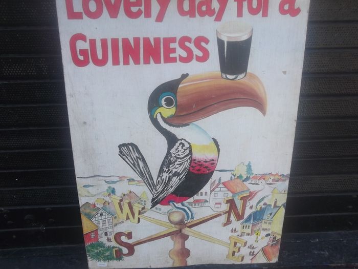 a hand painted perched guinness toucon  on board