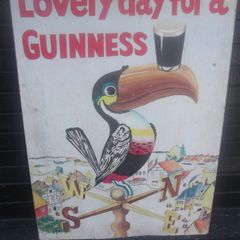 a hand painted perched guinness toucon  on board