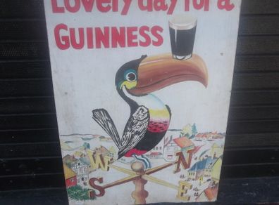 a hand painted perched guinness toucon  on board