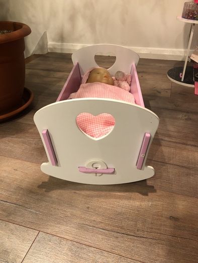 Doll crib with a baby
