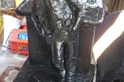 Large Cowboy Sculpture is titled Cutting the Dust and was created by artist Michael Garman. It is a Western Themed piece featuring a Cowboy Leaning Against a Counter,