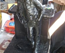 Large Cowboy Sculpture is titled Cutting the Dust and was created by artist Michael Garman. It is a Western Themed piece featuring a Cowboy Leaning Against a Counter,