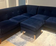 Navy velvet corner sofa and footstool