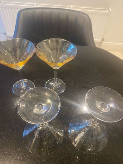 Set of four amber and plain glass martini or cocktail glasses