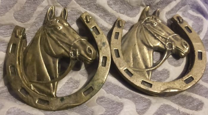 two brass horse shoe door knockers