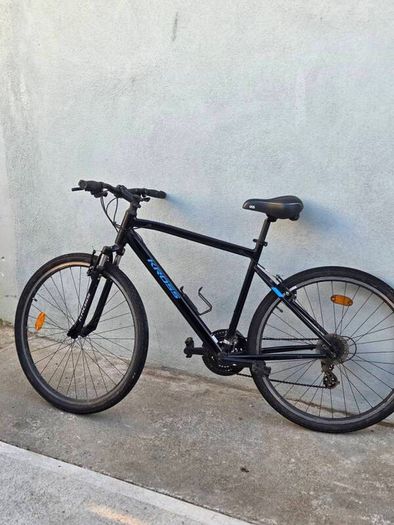 Two bikes one mountain one is a type of racing mountain bike