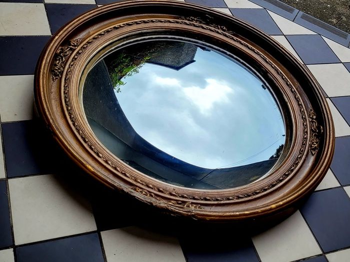 Antique gilt wood floral motif convex mirror