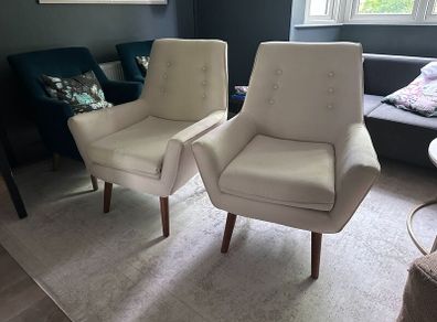 Two creme stylish armchairs