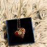 Heart-Shaped Pendant Necklace with Red Glass Heart and Wing Details Image 9