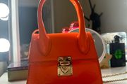 orange small handbag with a chain