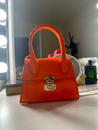 orange small handbag with a chain