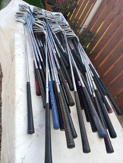 A selection of golf clubs and bags. All right handed clubs.