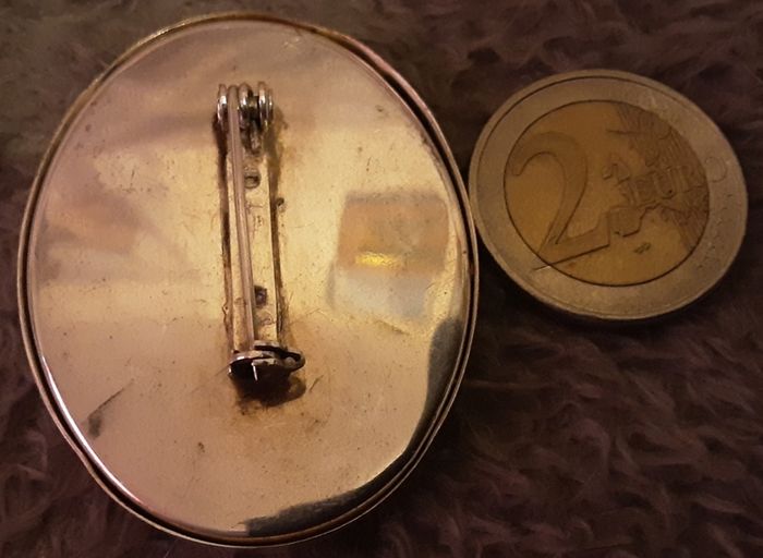 white metal brooch
