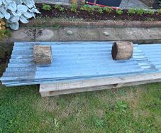 Corrugated galvanised cladding sheets.