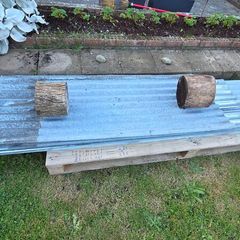 Corrugated galvanised cladding sheets.