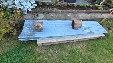 Corrugated galvanised cladding sheets.
