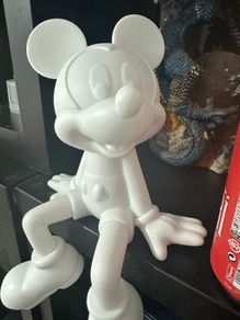 White Mickey Mouse seating ornament.