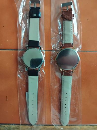 2 mens watches with leather straps.