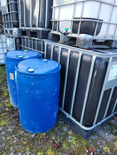 IBC tanks and blue barrels