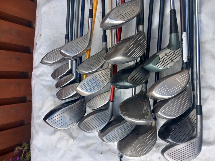 A selection of golf clubs and bags. Golf balls