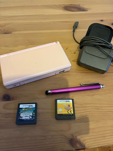 Pink Nintendo DS lite with charger and games