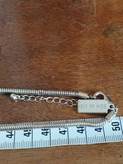 BEN DE LISI long necklace with a ball pendant.