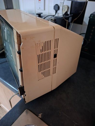 Ideal Prop, Vintage Working Boots Audio TV12 Portable Black and White CRT Television, featuring a cream plastic casing with side control dials and a 12 inch screen. Designed with dual power capabilities supporting standard mains voltage (240V) as well as 