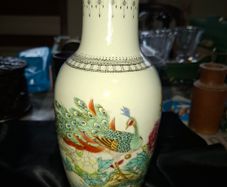 Chinese porcelain vase from the Jingdezhen region featuring a hand painted peacock and floral motif., Postage Available