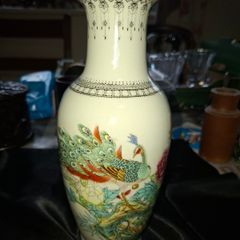 Chinese porcelain vase from the Jingdezhen region featuring a hand painted peacock and floral motif., Postage Available