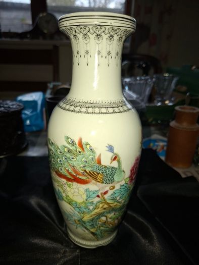 Chinese porcelain vase from the Jingdezhen region featuring a hand painted peacock and floral motif., Postage Available