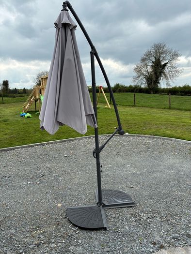 Large parasol and two weights. Bought for 170 last summer. Selling due to getting a pergola installed