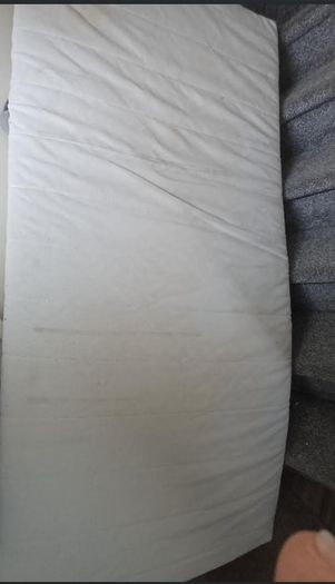 Twin bed, quite high, to store things underneath