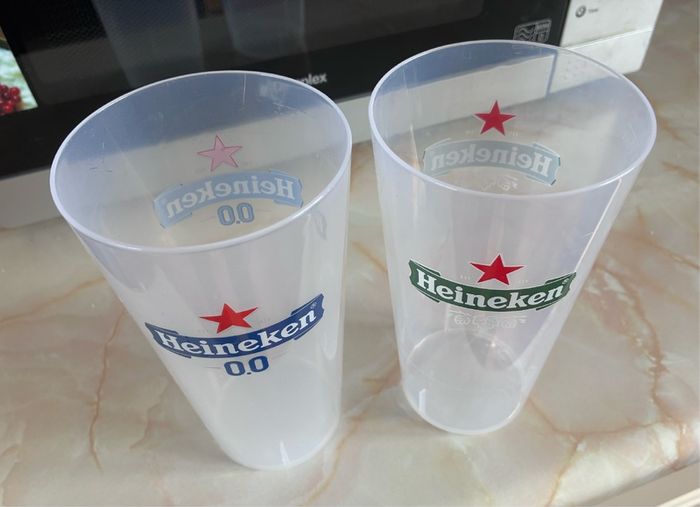 2 plastic Heineken glasses