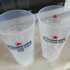 2 plastic Heineken glasses