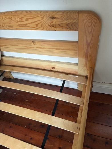 Single slatted wooden bed