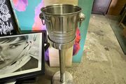 freestanding stainless-steel champagne/wine cooler with removable handled bucket.