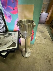 freestanding stainless-steel champagne/wine cooler with removable handled bucket.