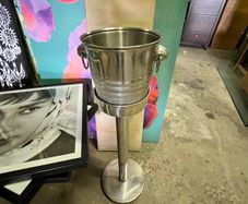 freestanding stainless-steel champagne/wine cooler with removable handled bucket.