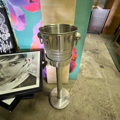 freestanding stainless-steel champagne/wine cooler with removable handled bucket.