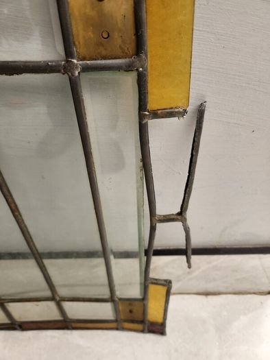 Vintage leaded glass with curved brass screen .