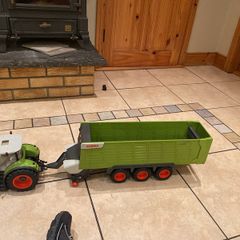 Claas remote control tractor with triaxle silage wagon