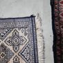 tiny wool rug...small mark on fringe. Image 2