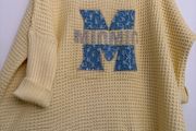 Delightful Lemon Sloppy Joe jumper with shiny motif