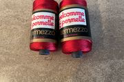 Two spools of red viscose knitting and crochet yarn