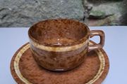 Brown and beige teacup and saucer
