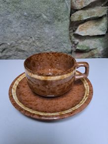 Brown and beige teacup and saucer